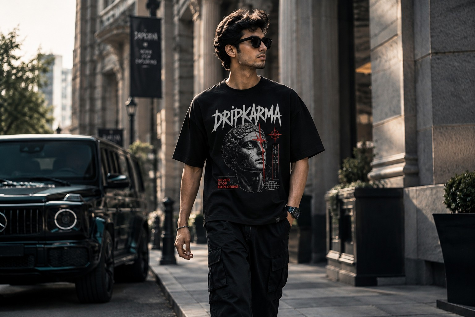 DRIPKARMA model wearing an oversized graphic T-shirt on an urban road